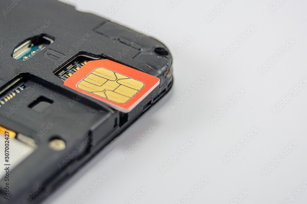 SIM card close-up next to the connector in the smartphone, phone SIM card close-up next to the connector in the smartphone, phone