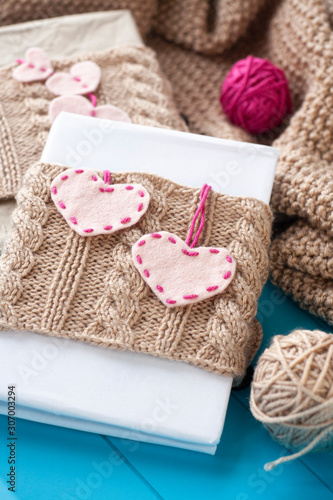 One old notebook in knitted cover with felt hearts.