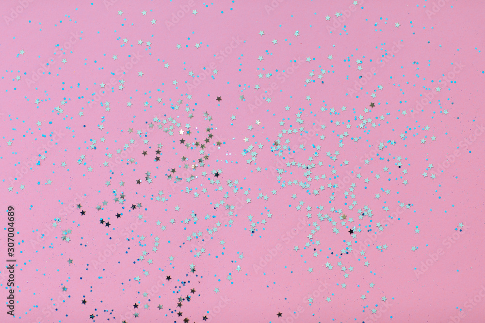 A scattering of stars on a pink background, Christmas holiday background, pastel colors.
