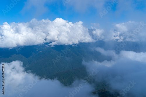 tops of green mountains in the clouds, scenic views high in the mountains