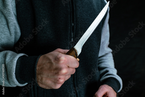 A man holds a kitchen knife in his hand