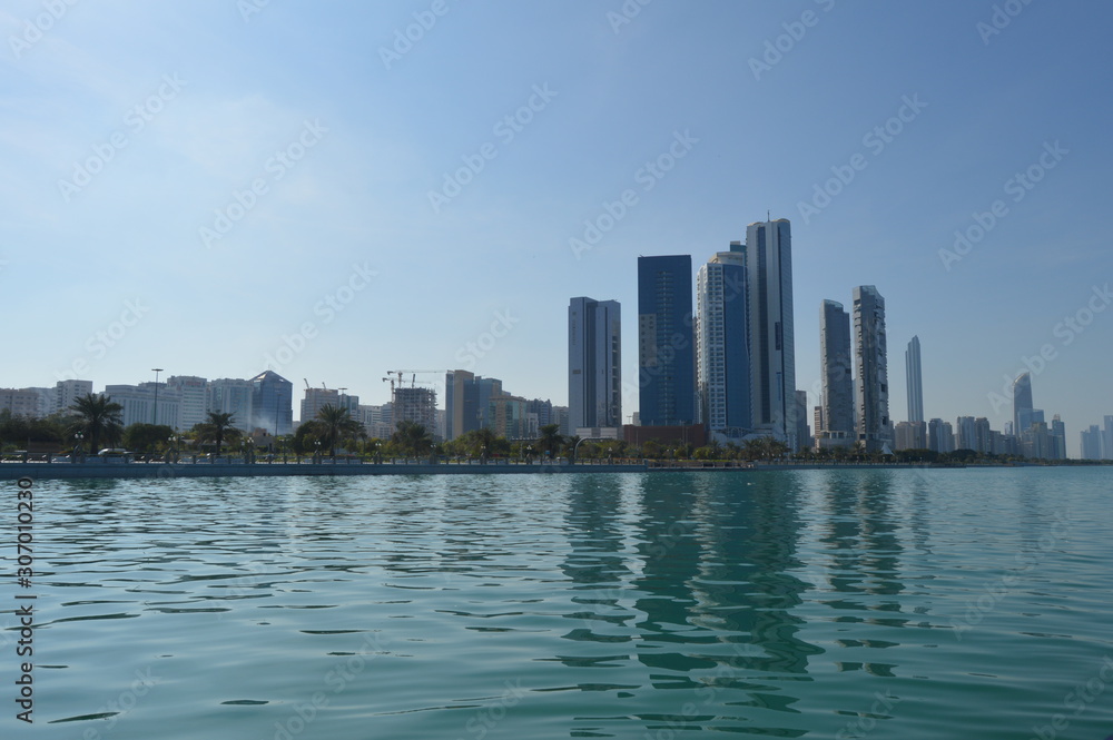 Abu Dhabi city skyline along Corniche beach taken from a boat