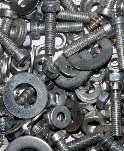 Collection of Old Bolt, Screws, Nuts Engineering Metal Tools on White Background © squeebcreative