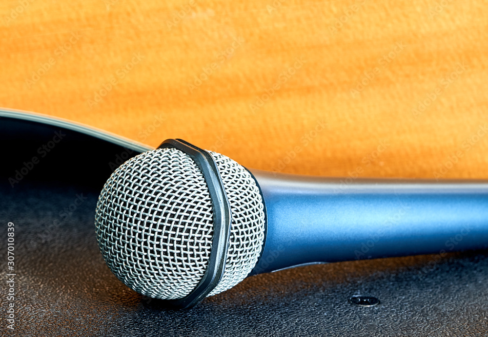 Obraz premium microphone and guitar are on the table