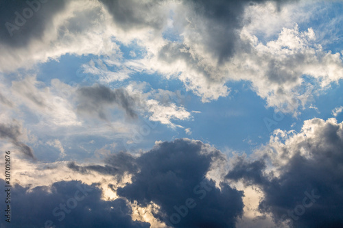 the sun shining through the clouds against the blue sky, light clouds in the sky