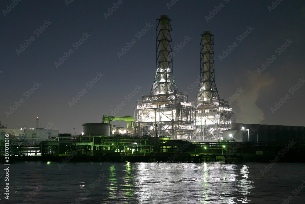 Tokyo,Japan-December 1, 2019: Night view of heat power plants viewed from a boat in Kawasaki just after the sunset  