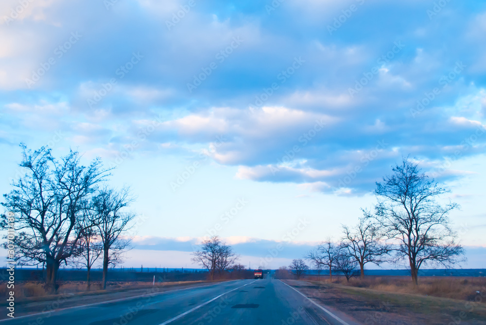 Fototapeta premium Road under the evening blue sky