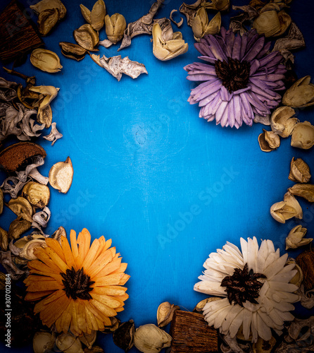  frame with flower petals on a wooden background