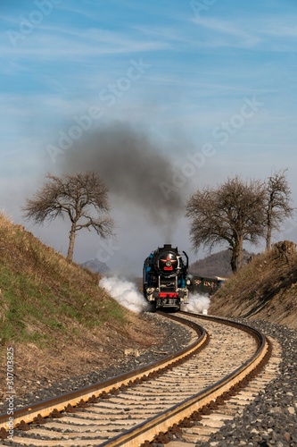 A steam passenger train arrives 