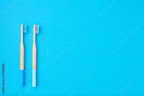 Toothbrushes on blue background top view copy space. Tooth care  dental hygiene and health concept.