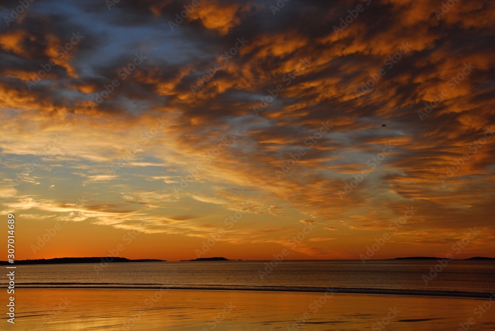 Colorful Sunrise over beach during low tide