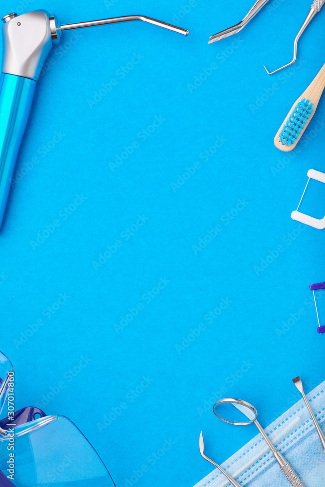 Dentist tools over blue background top view copy space flat lay. Tooth care, dental hygiene and health concept.