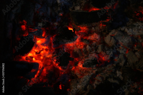 Smouldering coals at night. Decaying charcoal, New Year's Eve barbecue season