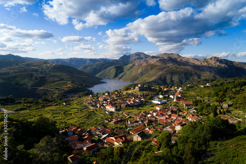 Aerial panoramic view of the historic village of Lindoso, with the surroundings mountains and lake, at the Peneda Geres National Park, in Portugal.