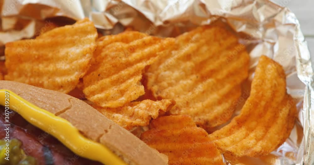 Video Slide Across Grilled Hot Dog With Chips Video Slide Across Grilled Hot Dog With Chips