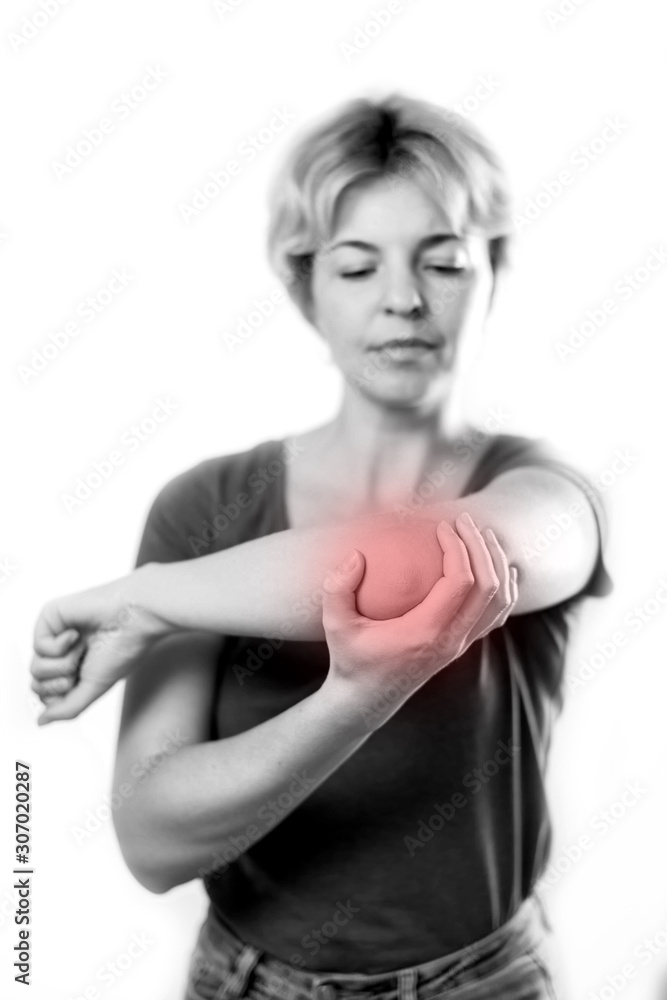 Woman feels elbow pain isolated. People, healthcare and medicine Woman feels elbow pain isolated. People, healthcare and medicine