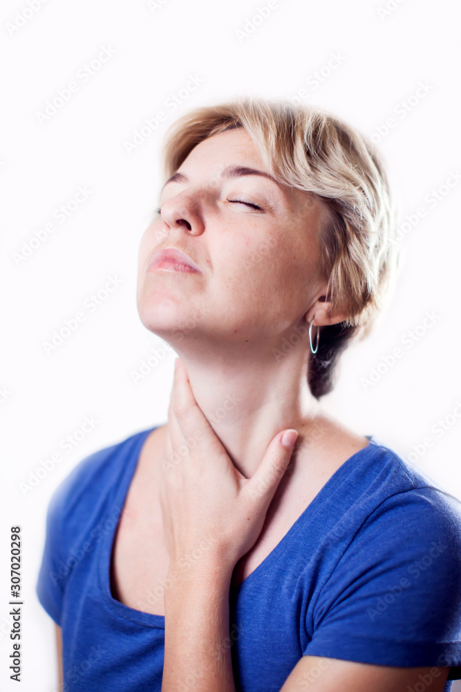 Woman feels throat pain isolated. People, healthcare and medicine concept Woman feels throat pain isolated. People, healthcare and medicine concept