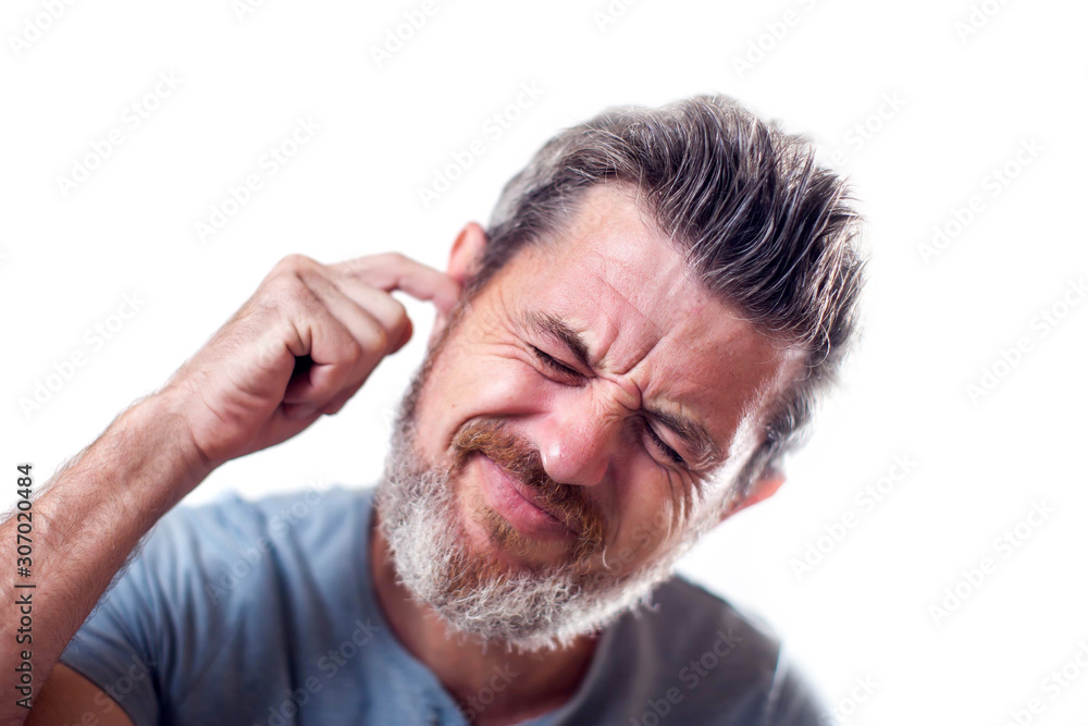Obraz premium Man feels ear pain isolated. People, healthcare and medicine concept