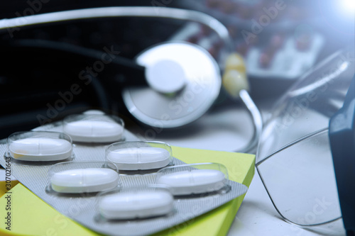 Medical and pharmaceutical concept, antibiotic pills stethoscope on the doctor’s desktop.
