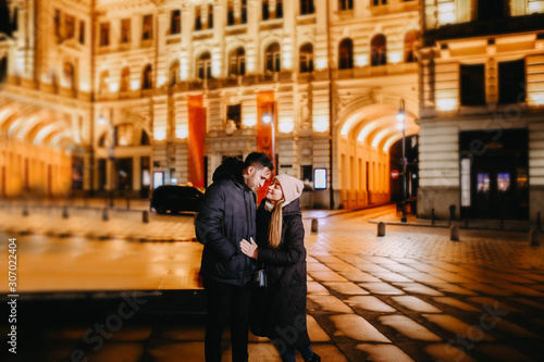 loving couple of travelers in the winter in a European city for Christmas and New Year.