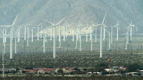 Wind turbines behind houses in mountain desert Southern California.mov photo