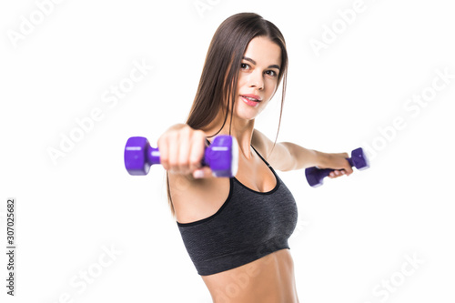 Beautiful and sporty young woman lifting up weights against white background.