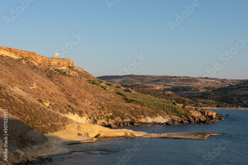 Hills at the sea shore during sunset. Golden Bay, Ghajn Tuffieha, Malta. 