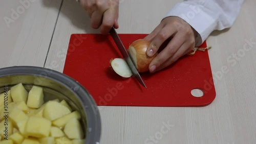 Woman chef prepares and cutting onions in the kitchen. Gootage.