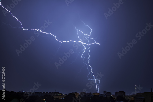 Bright lightning in the black sky over the city