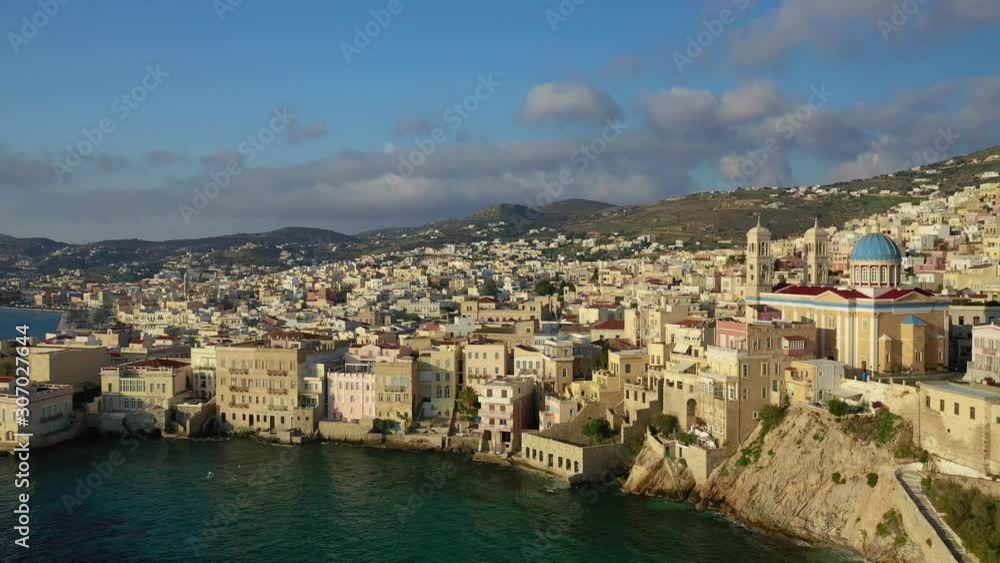 Aerial drone video of picturesque district built by the sea of Vaporia in main town of Syros or Siros island Ermoupolis and famous church of Agios Nikolaos, Cyclades, Greece Aerial drone video of picturesque district built by the sea of Vaporia in main town of Syros or Siros island Ermoupolis and famous church of Agios Nikolaos, Cyclades, Greece