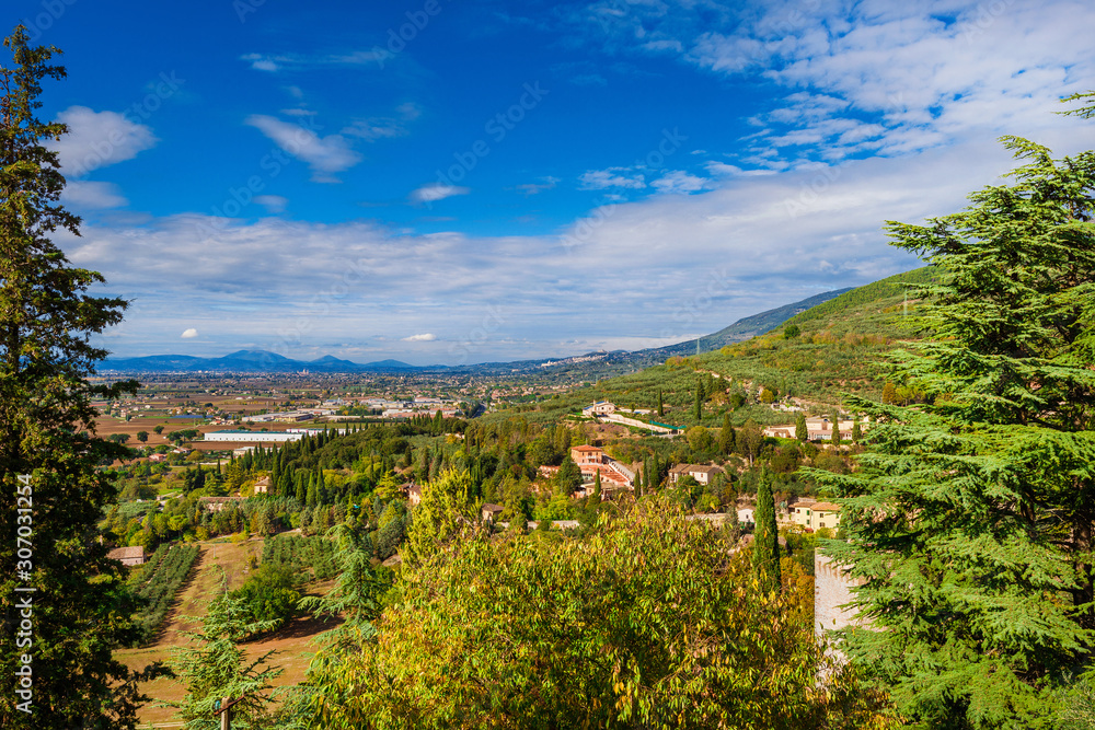 View of Umbria countryside with the ancient town of Assisi from the Spello panoramic terrace View of Umbria countryside with the ancient town of Assisi from the Spello panoramic terrace