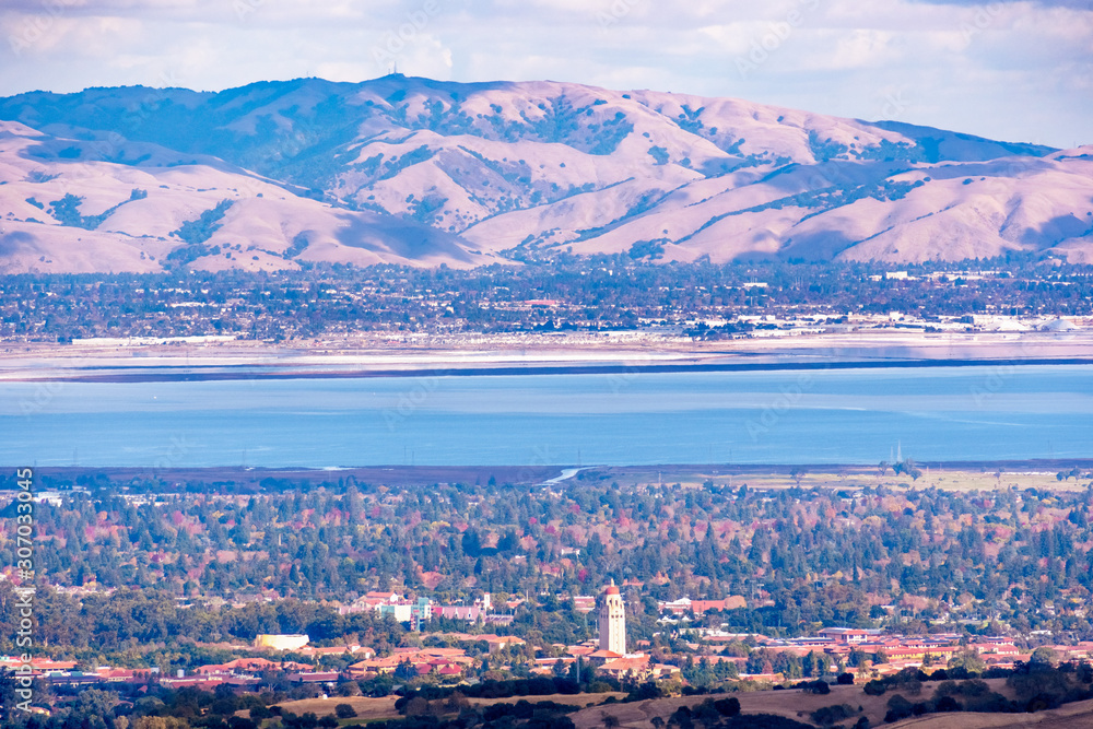 Aerial view of Stanford University amd Palo Alto, San Francisco Bay Area; Newark and Fremont and the Diablo mountain range visible on the other side of the bay; Silicon Valley, California