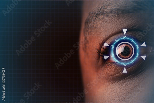 laser or lasik eye surgery concept, african american male brown eyes with digital overlay photo