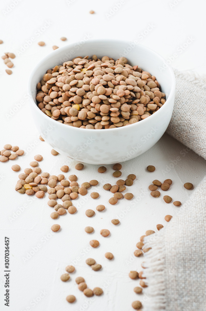 Dried green lentils on a white plaster textured background Dried green lentils on a white plaster textured background