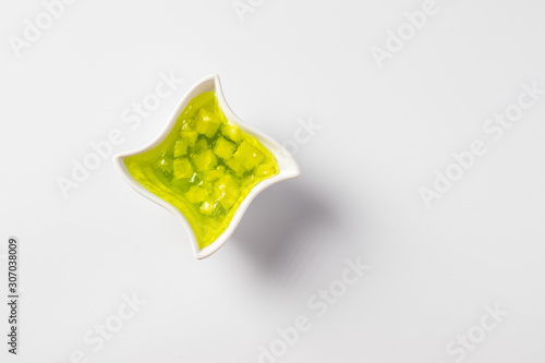 Cucumber jam in a bowl on a white background