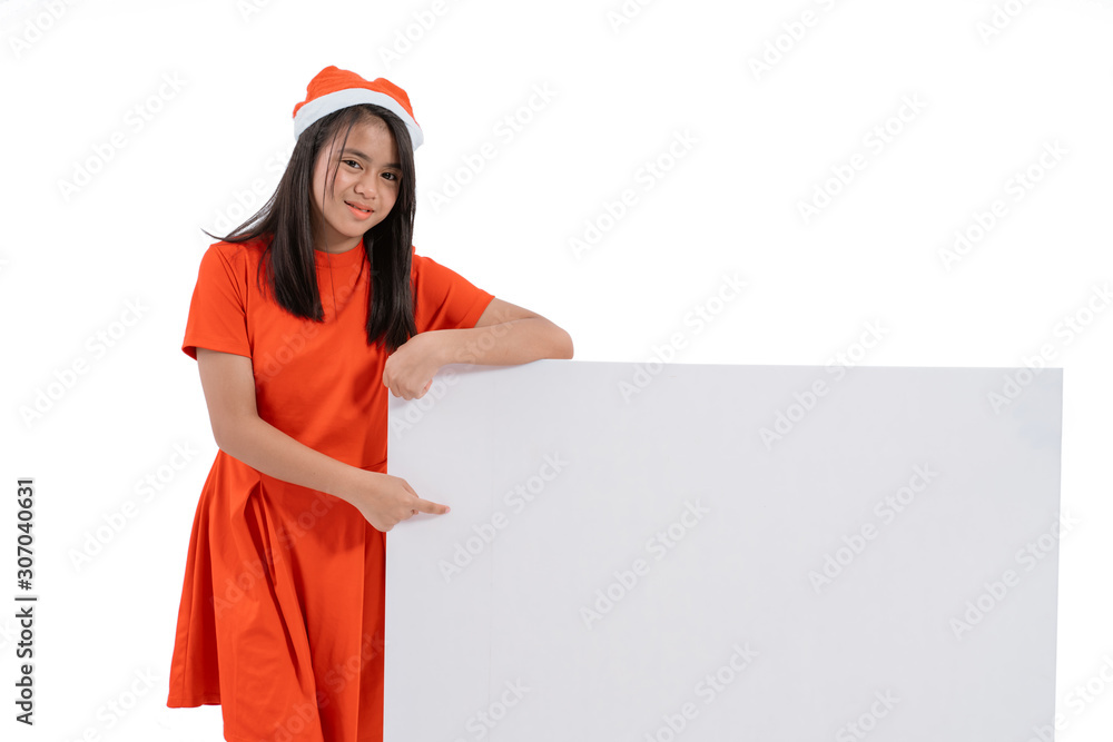 portrait of kid with santa claus hat smiling holding blank board portrait of kid with santa claus hat smiling holding blank board