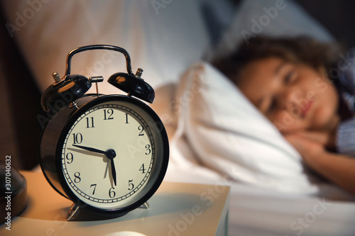 Alarm clock on table in bedroom of little girl