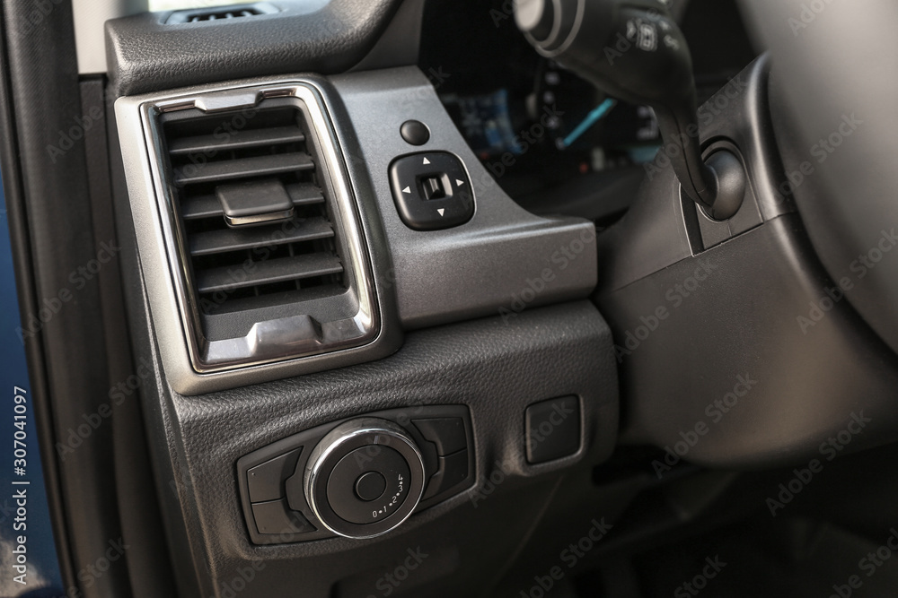 Fototapeta premium Air conditioner and lighting control buttons in modern car