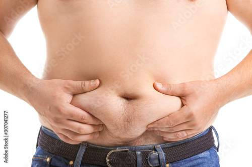 Overweight man touching his...