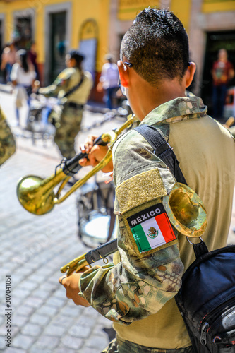 Obraz na płótnie Joven marchando y tocando trompeta