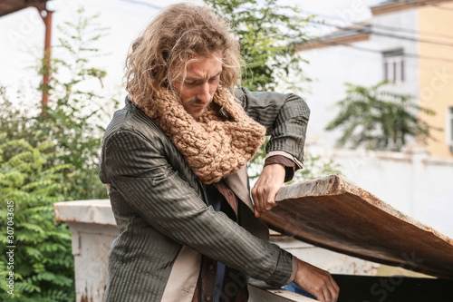 Poor homeless man looking f...