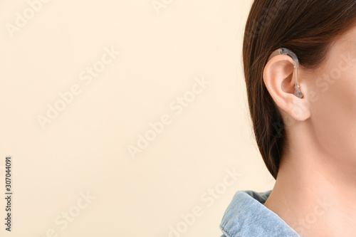 Young woman with hearing ai...