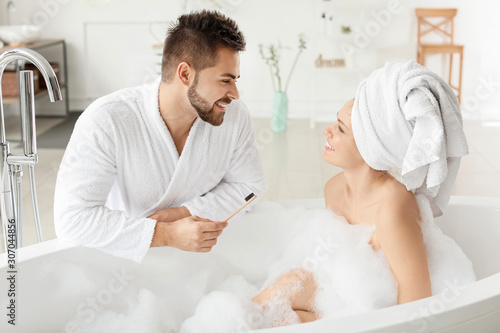 Morning of happy young couple in bathroom