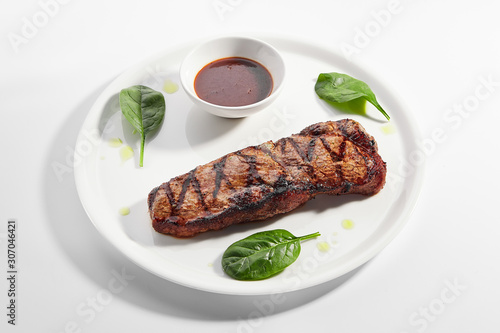 Striploin steak with sauce close up photo