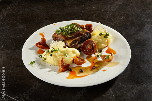 Beef brisket and mashed potato on white plate