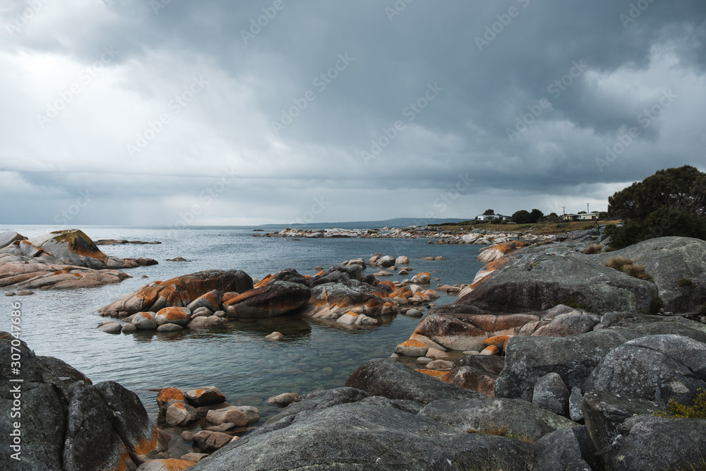 View on the rocky coastline in Bay of fires, Tasmania before storm