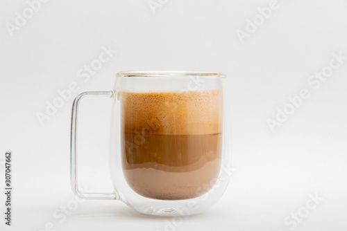 Hot Latte in double layer clear glass on white background