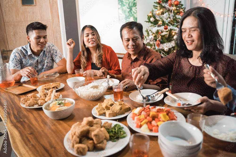 portrait of indonesian family having christmas eve dinner together at home