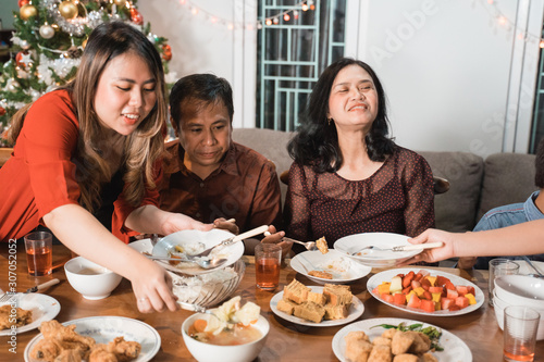 portrait of indonesian family having christmas eve dinner together at home