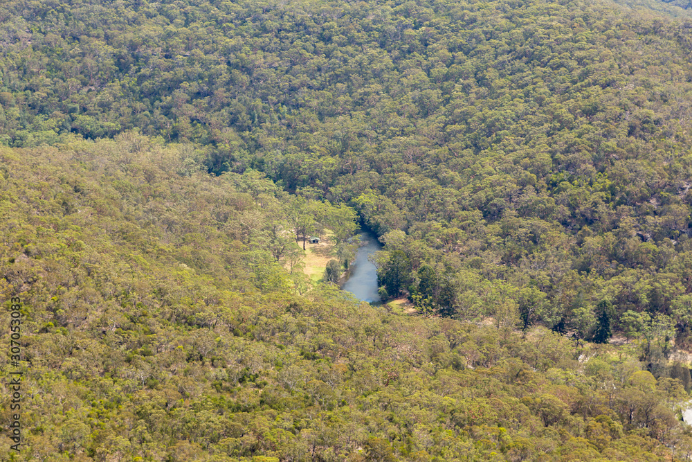 Cabin in the woods in secluded river in very remote australian bush land aerial